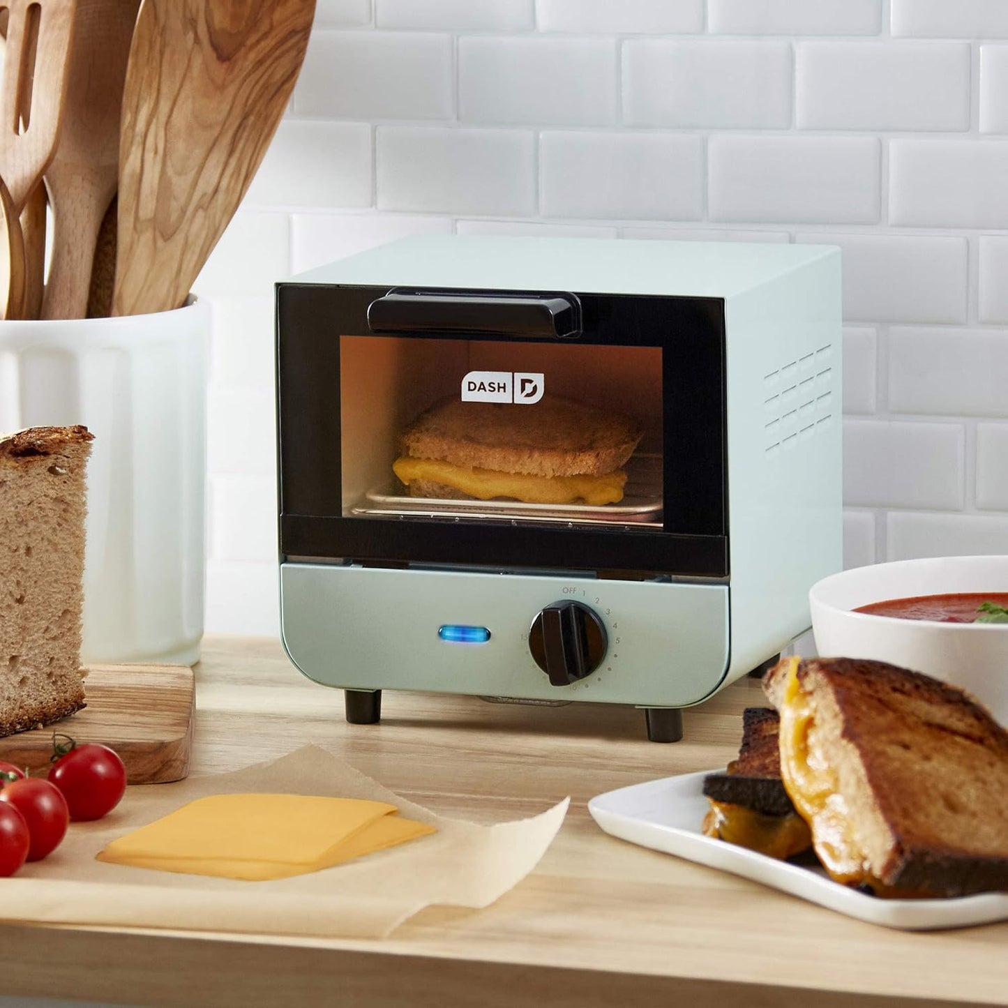Dash DMTO100GBAQ04 Mini Toaster Oven Cooker and Grill Combo for Bread, Bagels, Burgers, Sandwiches - Aqua Color